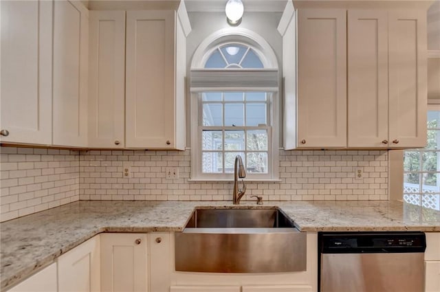 kitchen featuring dishwasher, white cabinets, and light stone counters