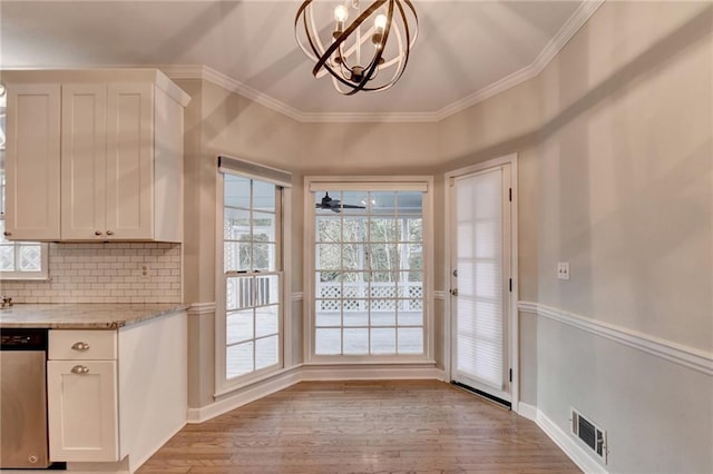 doorway to outside featuring ceiling fan with notable chandelier, crown molding, and light hardwood / wood-style flooring