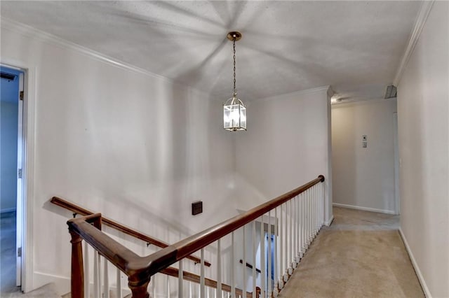 corridor featuring ornamental molding and light colored carpet