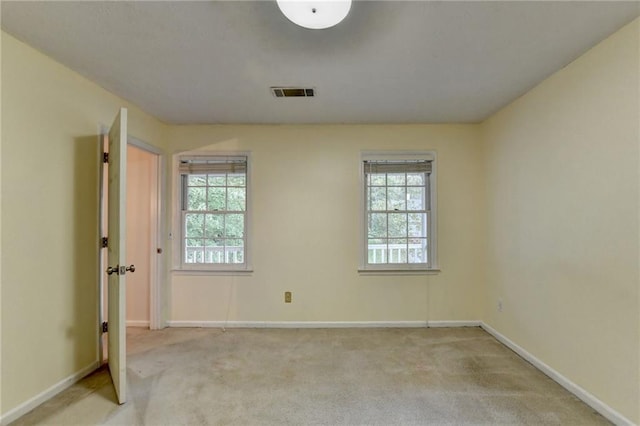 carpeted empty room featuring a healthy amount of sunlight