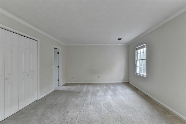 unfurnished bedroom with ornamental molding and light colored carpet