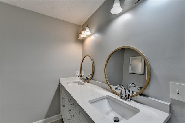 bathroom with vanity and a textured ceiling