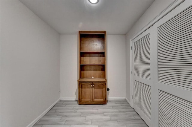 interior space with light wood-type flooring and a closet