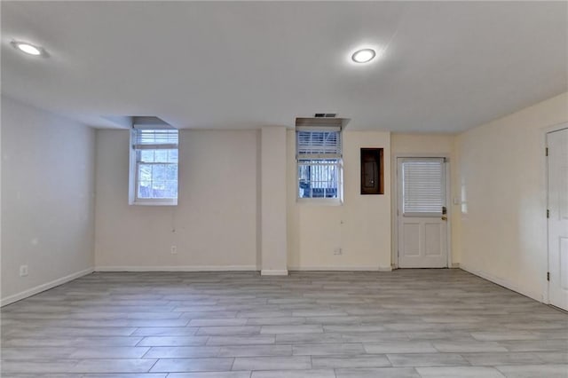 basement with light hardwood / wood-style flooring