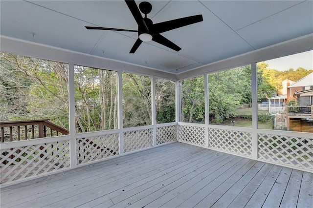 unfurnished sunroom with a wealth of natural light and ceiling fan