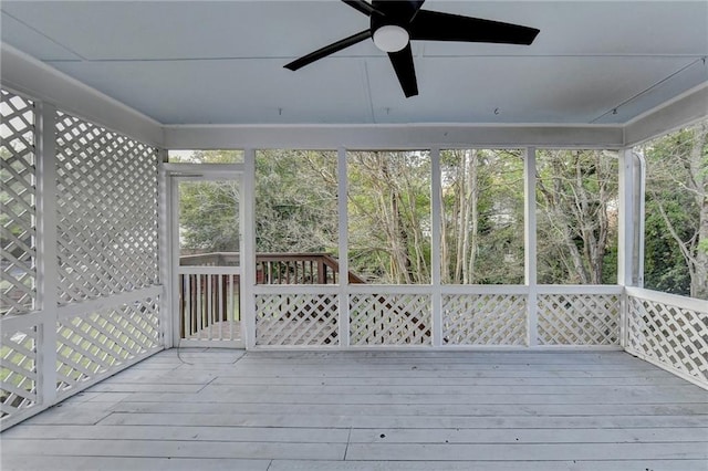 unfurnished sunroom featuring ceiling fan