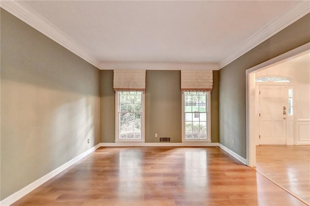 spare room featuring ornamental molding and wood-type flooring