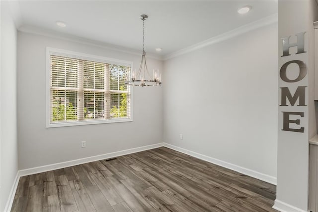 unfurnished dining area with dark hardwood / wood-style flooring, ornamental molding, and a notable chandelier