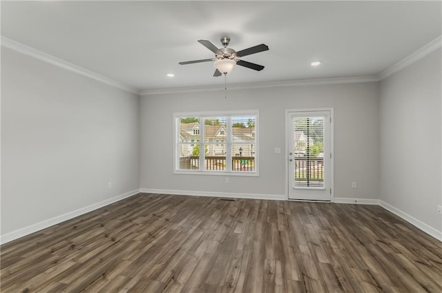 empty room featuring ceiling fan, crown molding, and dark wood-type flooring