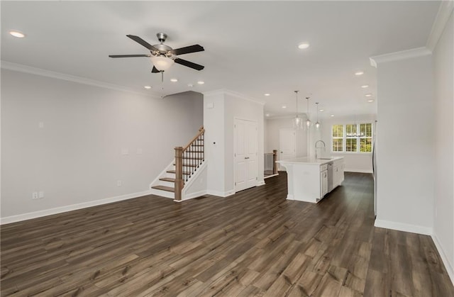 unfurnished living room featuring ceiling fan, dark wood-type flooring, crown molding, and sink