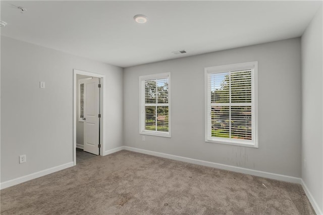 empty room featuring light carpet