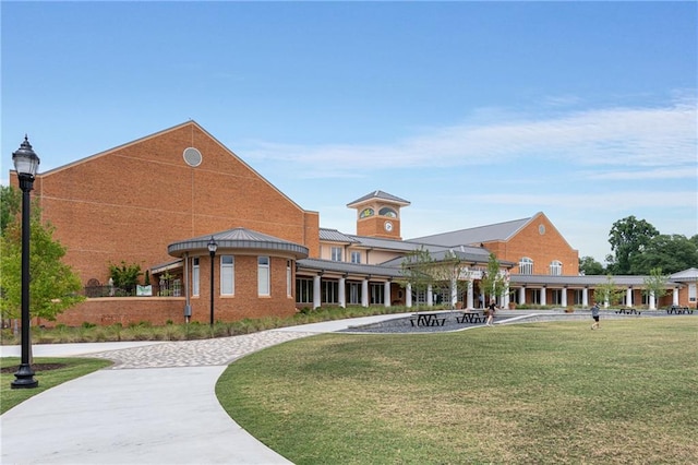 view of property's community with a lawn