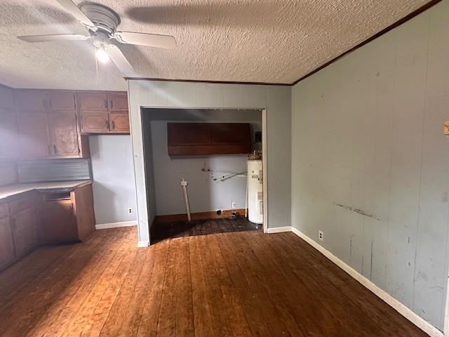 29 Ivy St, Porterdale, GA 30014 - unfurnished living room with water heater, hardwood / wood-style flooring, ceiling fan, a textured ceiling, and baseboards