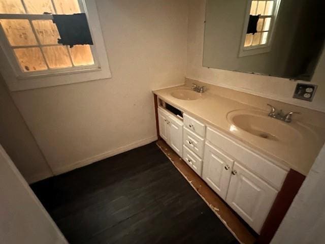29 Ivy St, Porterdale, GA 30014 - bathroom featuring double vanity, healthy amount of natural light, wood finished floors, and baseboards