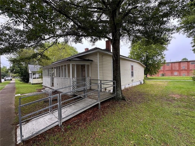 29 Ivy St, Porterdale, GA 30014 - view of side of property with a sunroom, a chimney, a yard, and crawl space