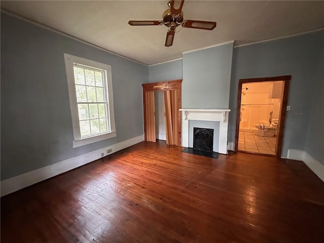 29 Ivy St, Porterdale, GA 30014 - unfurnished living room featuring ornamental molding, wood finished floors, baseboards, a fireplace with flush hearth, and ceiling fan