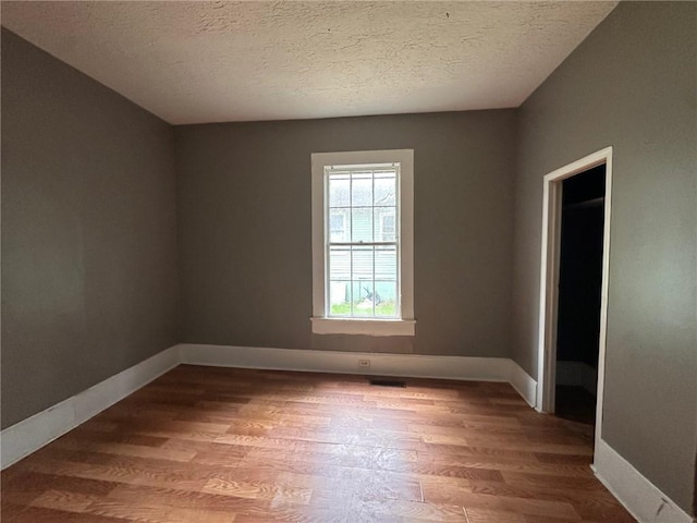 29 Ivy St, Porterdale, GA 30014 - unfurnished room featuring wood finished floors, baseboards, and a textured ceiling