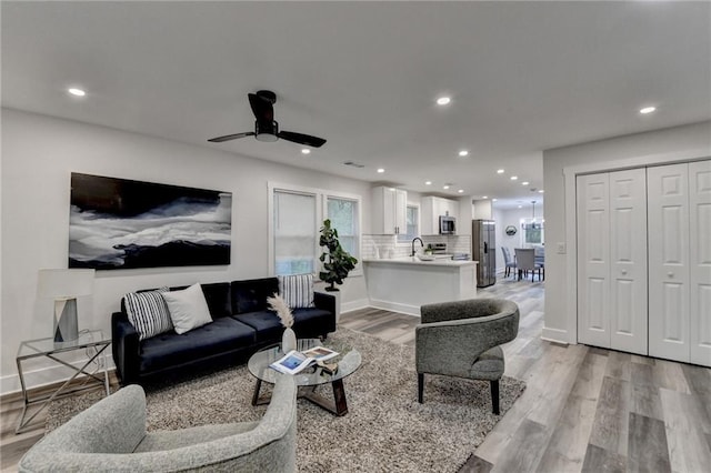 538 Center Hill Ave NW, Atlanta, GA 30318 - living room with baseboards, light wood-type flooring, recessed lighting, and a ceiling fan