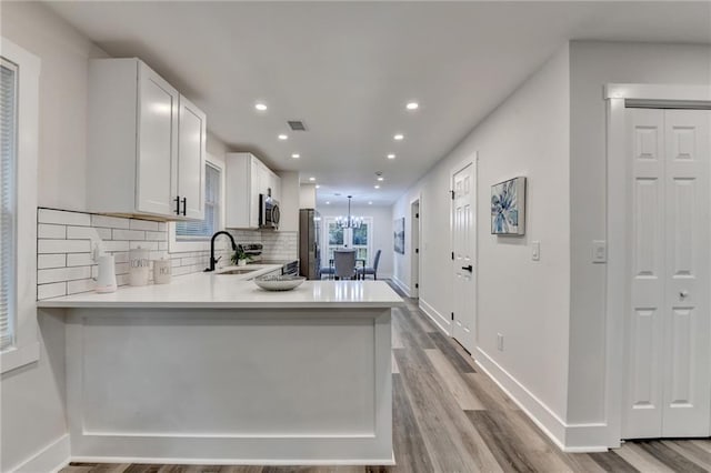 538 Center Hill Ave NW, Atlanta, GA 30318 - kitchen featuring a sink, light countertops, appliances with stainless steel finishes, recessed lighting, and wood finished floors