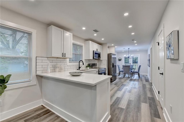 538 Center Hill Ave NW, Atlanta, GA 30318 - kitchen featuring visible vents, light countertops, a sink, stainless steel appliances, and decorative backsplash