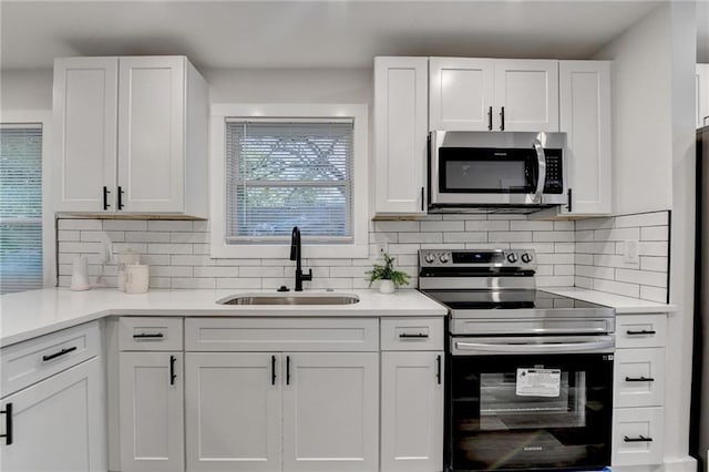 538 Center Hill Ave NW, Atlanta, GA 30318 - kitchen with appliances with stainless steel finishes, a sink, and white cabinets