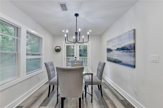 538 Center Hill Ave NW, Atlanta, GA 30318 - dining room with an inviting chandelier, visible vents, wood finished floors, baseboards, and plenty of natural light