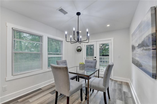538 Center Hill Ave NW, Atlanta, GA 30318 - dining area featuring visible vents, baseboards, an inviting chandelier, and wood finished floors