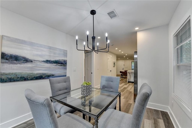 538 Center Hill Ave NW, Atlanta, GA 30318 - dining room with visible vents, baseboards, a notable chandelier, and wood finished floors