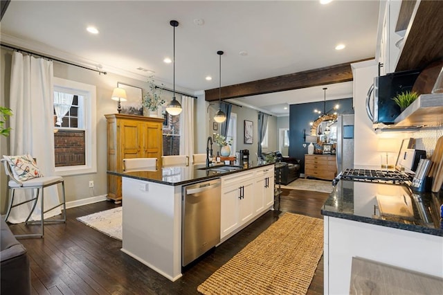 kitchen featuring decorative light fixtures, white cabinetry, sink, a kitchen island with sink, and stainless steel dishwasher