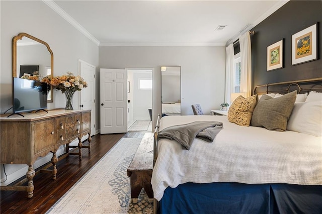 bedroom with crown molding, dark hardwood / wood-style flooring, and multiple windows