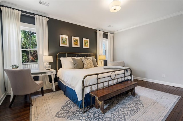 bedroom with multiple windows, crown molding, and wood-type flooring