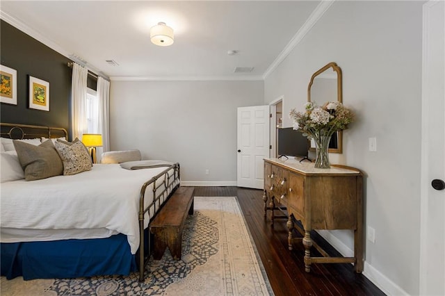 bedroom featuring crown molding and dark hardwood / wood-style flooring