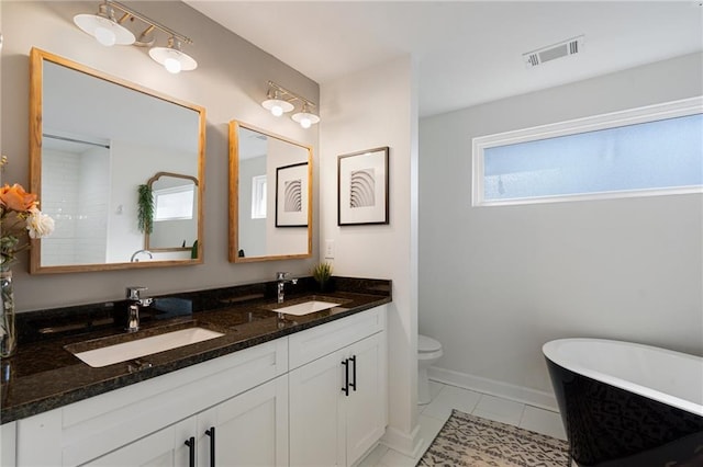 bathroom featuring vanity, toilet, and a bathtub