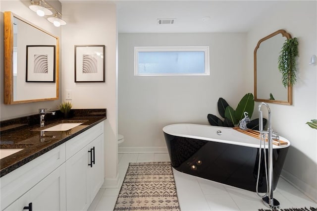 bathroom with vanity, toilet, and a bathing tub