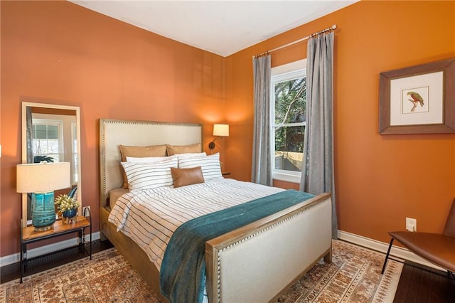 bedroom with dark wood-type flooring