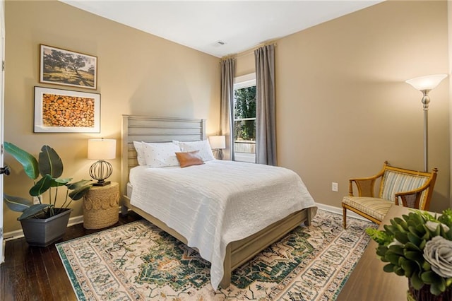 bedroom with dark hardwood / wood-style flooring