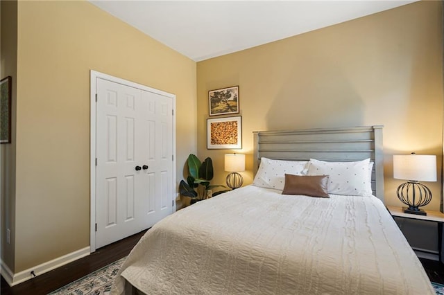 bedroom with a closet and dark hardwood / wood-style floors