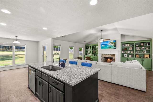 137 Evergreen Ridge Ct, Statham, GA 30666 - kitchen with a sink, a textured ceiling, ceiling fan, lofted ceiling, and a brick fireplace