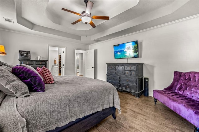 137 Evergreen Ridge Ct, Statham, GA 30666 - bedroom with a tray ceiling, wood finished floors, crown molding, ceiling fan, and baseboards