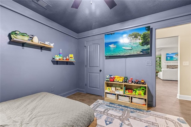 137 Evergreen Ridge Ct, Statham, GA 30666 - bedroom featuring baseboards, wood finished floors, a textured ceiling, and ceiling fan