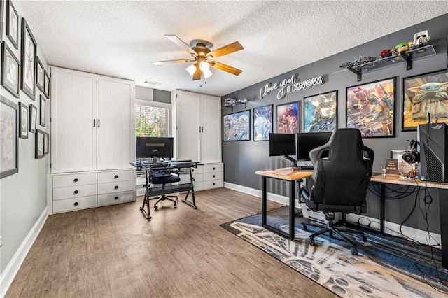 137 Evergreen Ridge Ct, Statham, GA 30666 - office area with wood finished floors, baseboards, a ceiling fan, and a textured ceiling
