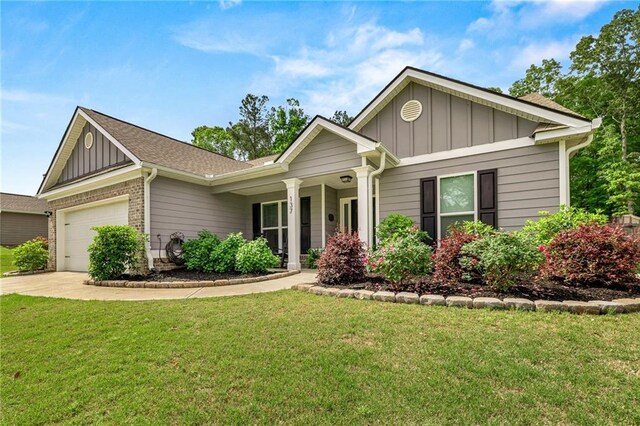 137 Evergreen Ridge Ct, Statham, GA 30666 - ranch-style home featuring board and batten siding, a front lawn, an attached garage, and driveway