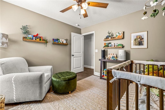 137 Evergreen Ridge Ct, Statham, GA 30666 - bedroom with wood finished floors, baseboards, a textured ceiling, and ceiling fan