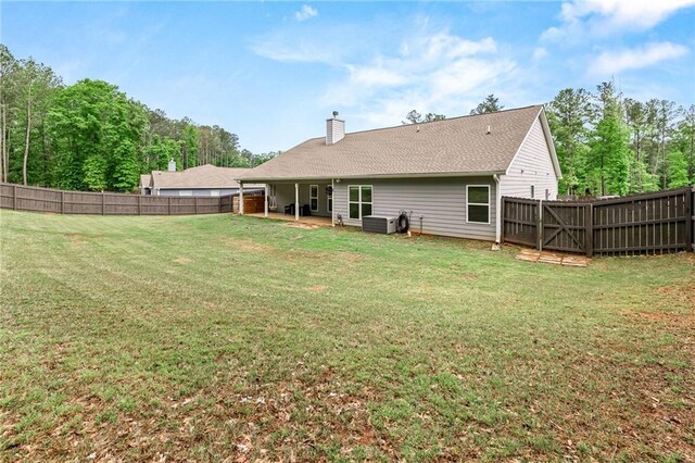 137 Evergreen Ridge Ct, Statham, GA 30666 - rear view of house with a chimney and central AC unit