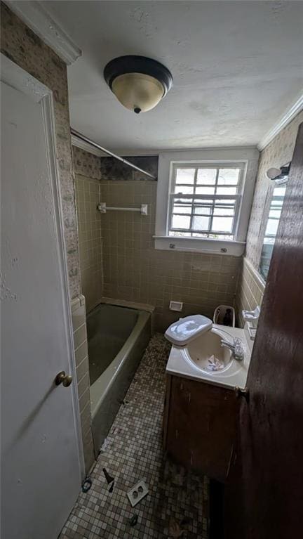 bathroom featuring shower / washtub combination, tile walls, toilet, vanity, and tile patterned flooring