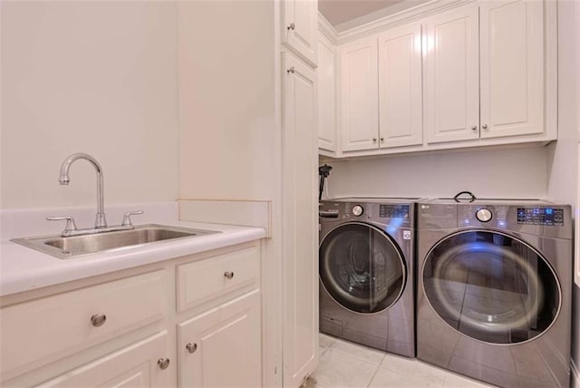 laundry area featuring independent washer and dryer, sink, cabinets, and light tile patterned floors