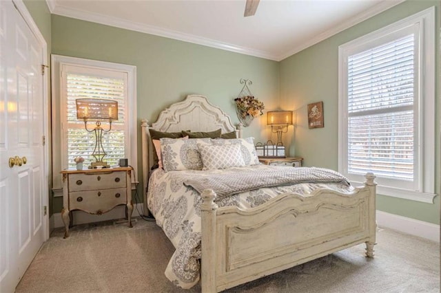 carpeted bedroom featuring crown molding and ceiling fan