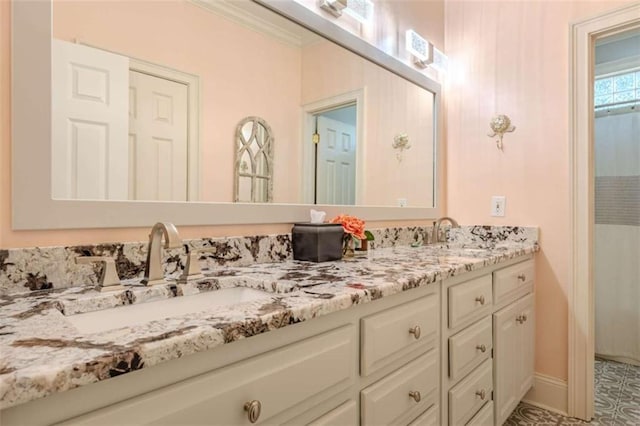 bathroom featuring crown molding and vanity