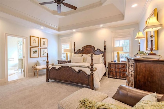 carpeted bedroom with crown molding, a raised ceiling, and multiple windows