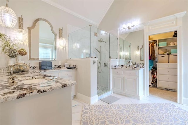 bathroom featuring a shower with door, ornamental molding, and vanity